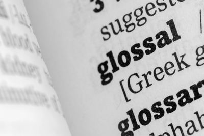 Image of the close-up of the word glossary in a dictionary.
