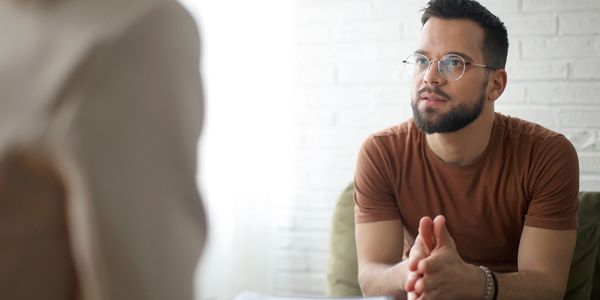 Man attentively listening during a therapy session.