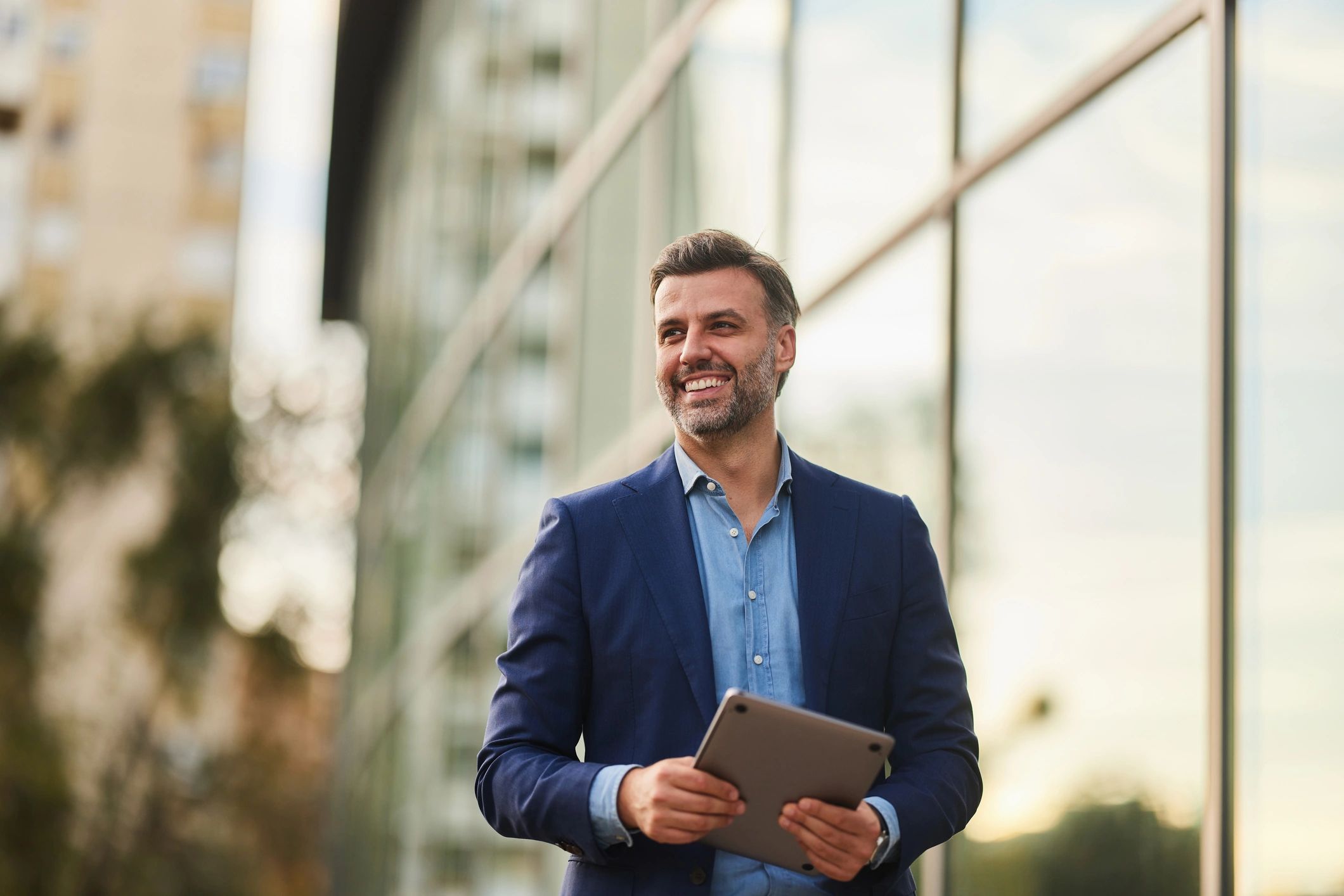 Male in outdoor setting holding an ipad