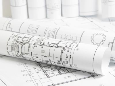 Rolled and unrolled architectural blueprints.