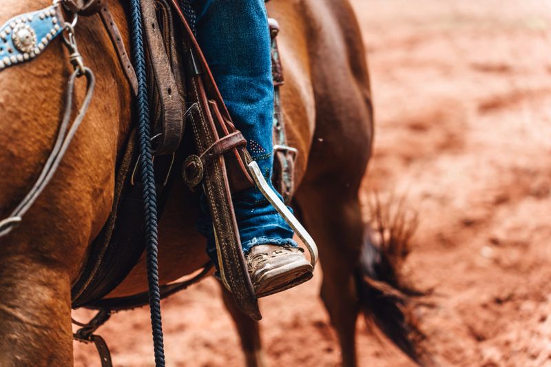 Close-up of boots in the horse's stirrup