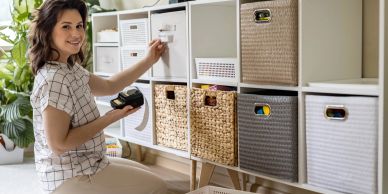 Woman organizing storage bins at home.