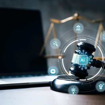 A gavel with AI symbols in front of a laptop and scales of justice.