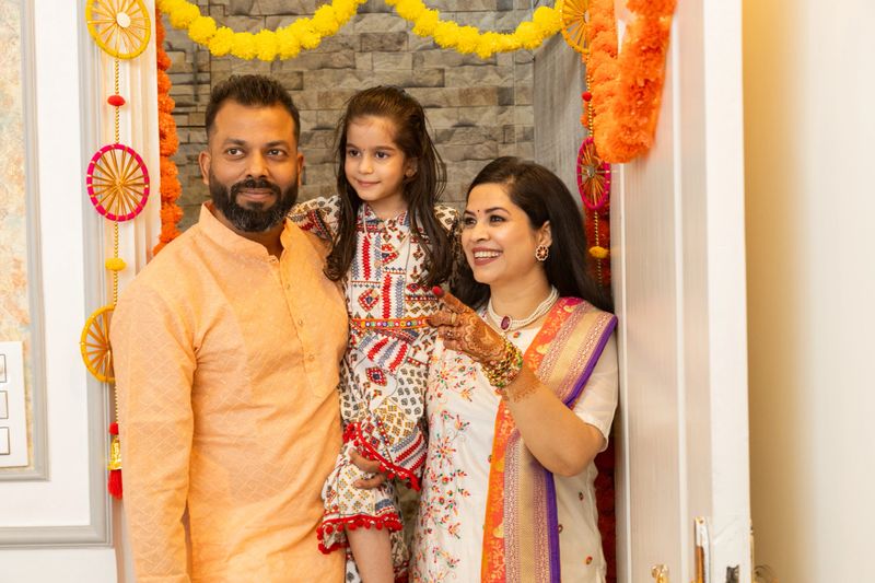 Happy indian family of three entering new house for the first time. festival purchase , family relationship concept