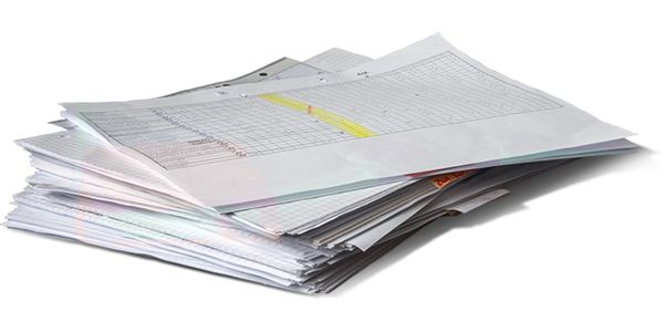 A stack of printed spreadsheet papers with charts and tables.