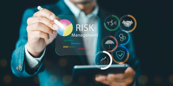 Businessman managing risk with digital tools and icons.
