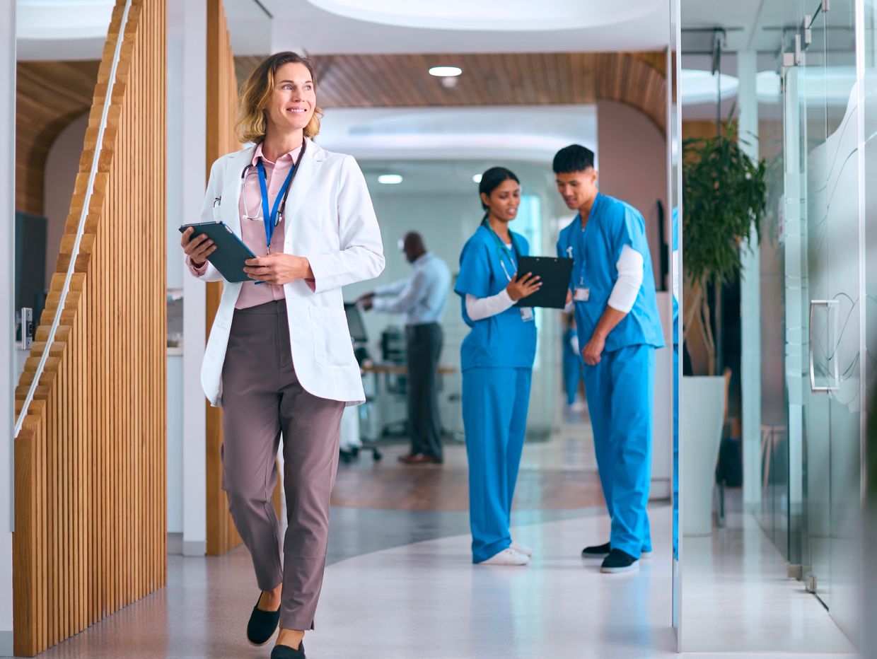 A doctor walking in the inside of hospital