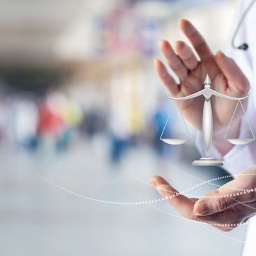 Doctor in white coat holding a digital justice scale symbol.