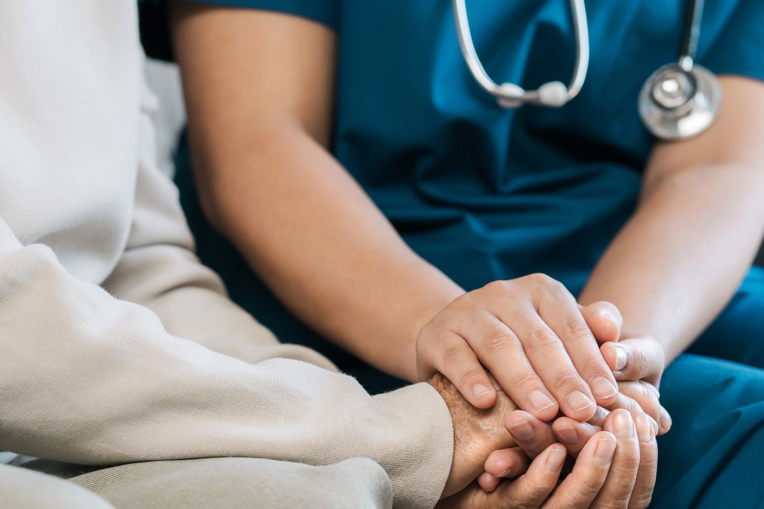 the doctor is holding the patient's hand
