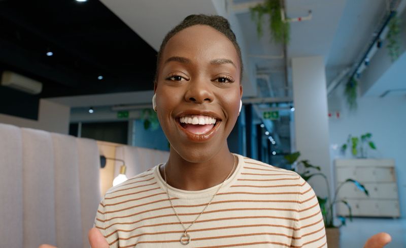 Woman on a video call using headphones in an office