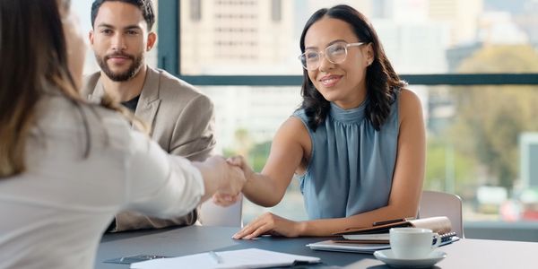 Insurance advisor meeting with clients to review coverage options in Miami, Florida.