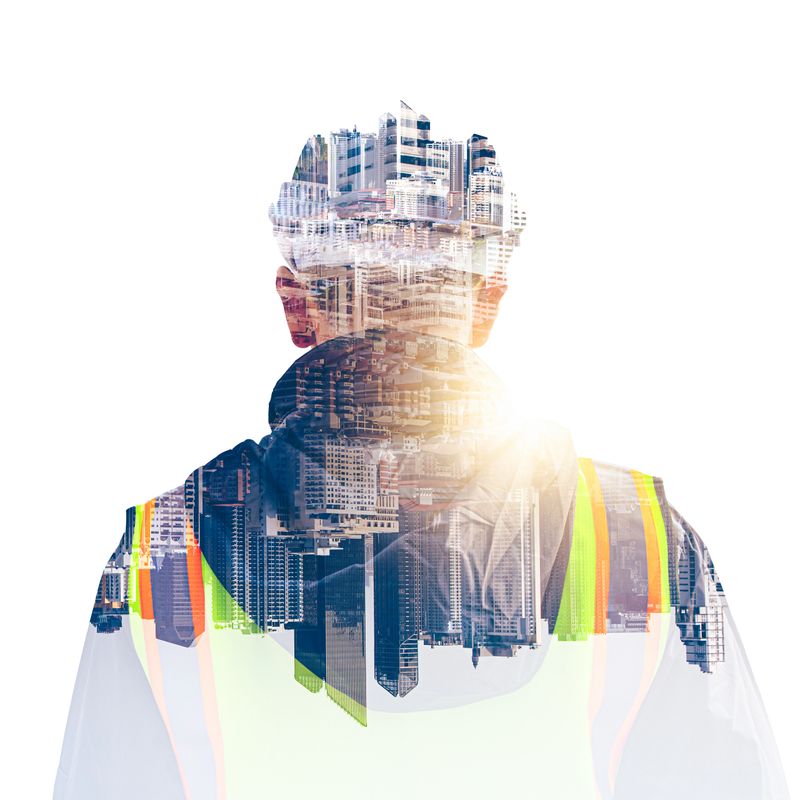 The double exposure image of the engineer thinking overlays with cityscape image with copy space. The concept of engineering, construction, futuristic and industry.