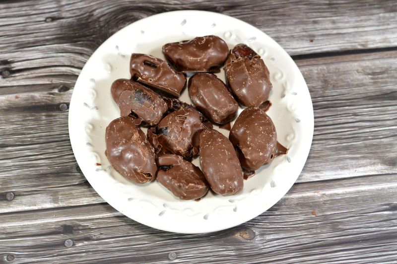 Chocolate-Covered Dates make for the best snack, treat, or dessert, tasty Saudi dates coated with brown chocolate layer, dates usually consumed in Ramadan month in Islamic countries, selective focus