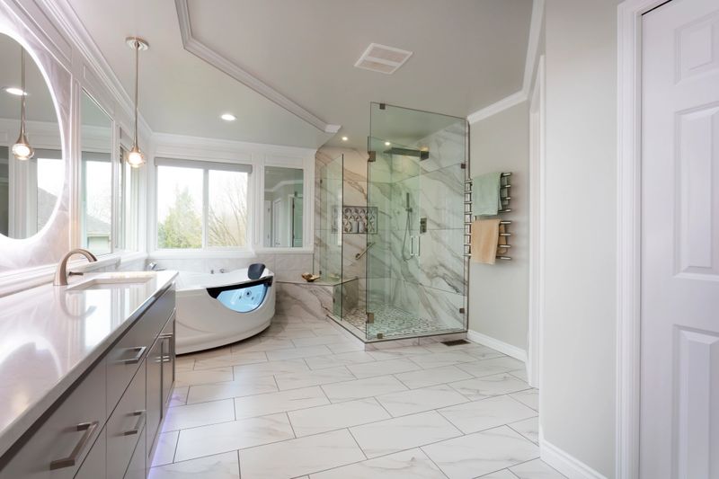 Spacious modern contemporary master bathroom with hot tub hot tube, large glass walk in shower, new stone counter, wall, mirrors, lighting plus towel warmer rack