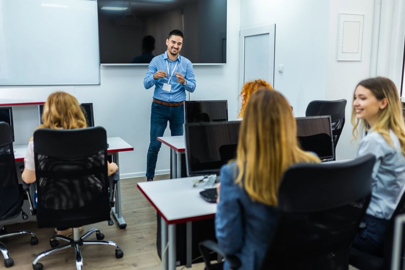 Educator and students in programming school.