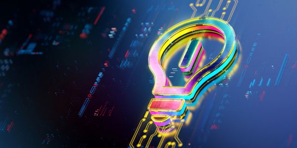 Colorful digital lightbulb on circuit board background.