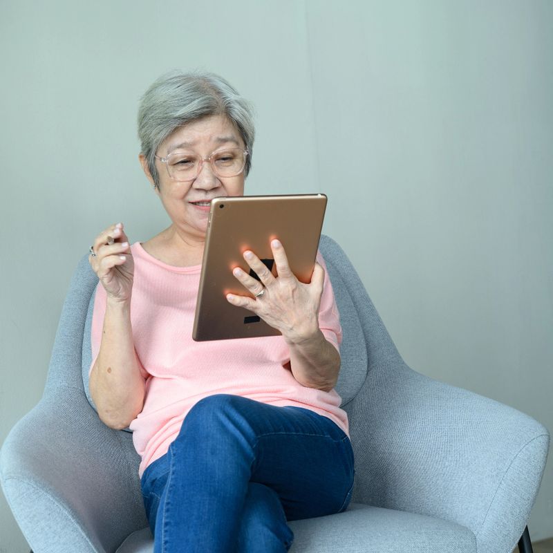 mature woman online interacting socially and  engaging in training and e-commerce