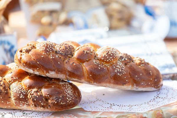 Fresh braided bread topped with sesame and sunflower seeds.