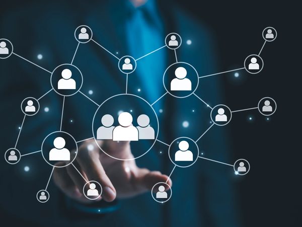 Person interacting with a digital network of connected user icons.