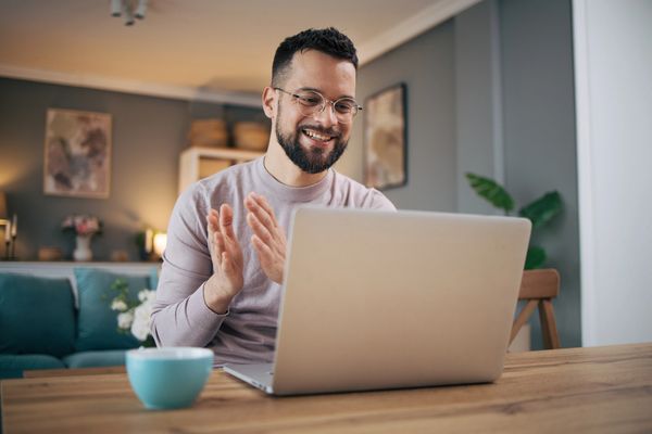 Image of man using Zoom on the laptop