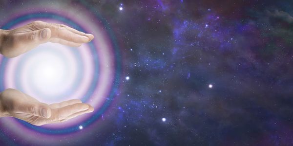 Cosmos background, hands holding spiraling light between hands. 