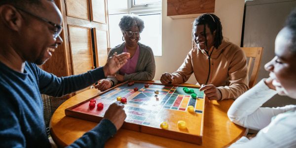 Four people enjoying a board game together.