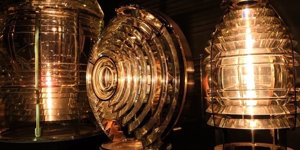The inside of a lighthouse lamp, made of amber glass