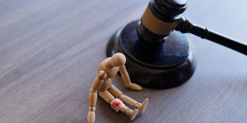 A wooden figure sitting on top of a table.