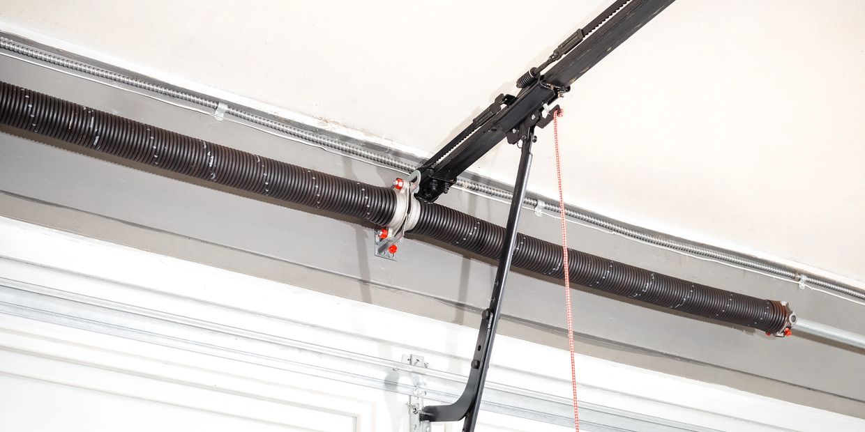 Close-up of a garage door spring and mechanism.