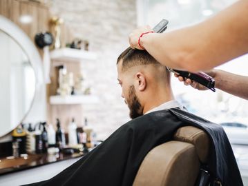 Man getting a haircut in a barbershop.