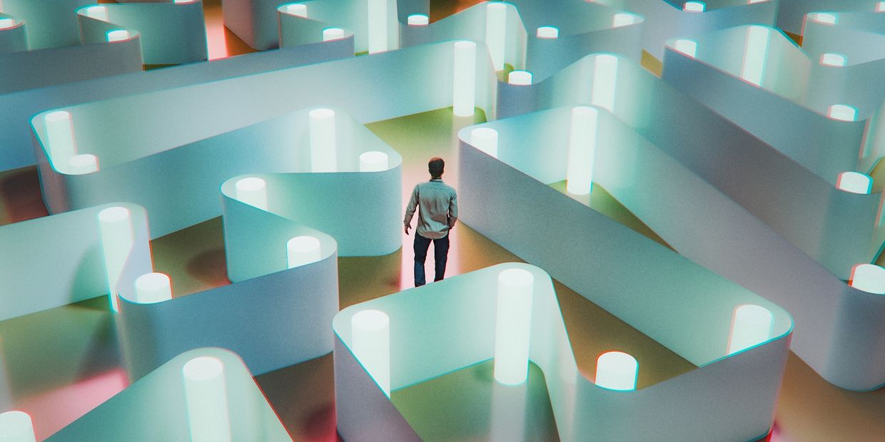 A person stands at the entrance of a glowing, futuristic maze.