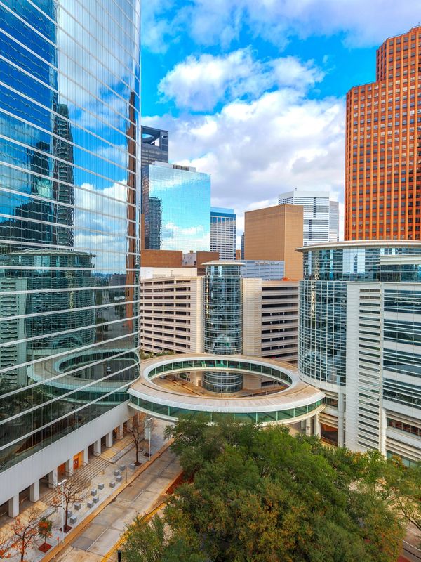 Downtown Houston skyscrapers with circular skybridge area near major convention venues.
