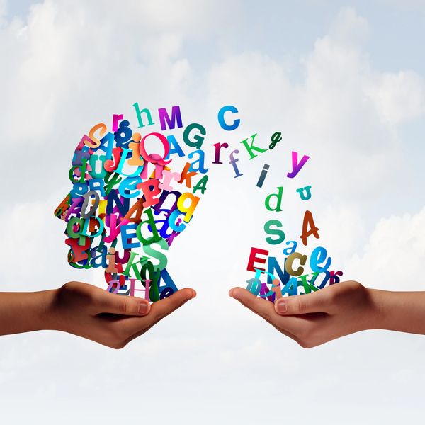 Two hands holding colorful scattered alphabet letters forming shapes.