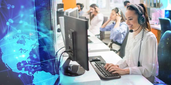 Customer service team working with headsets at computers.