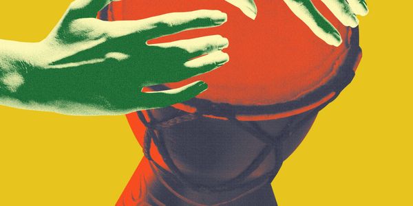 Close-up of hands playing a djembe drum with vibrant colors.