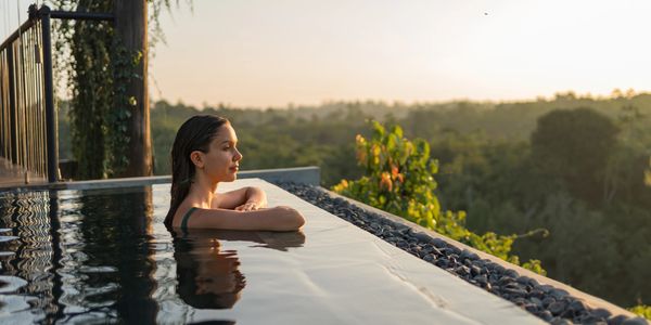 lady in an infinity pool enjoying the view