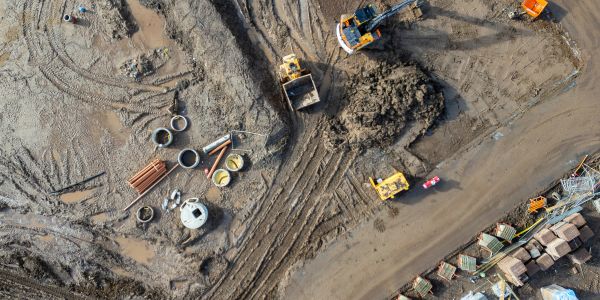 Aerial view of construction site with machinery and materials.