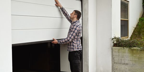 homeowner standing outside his garage door
