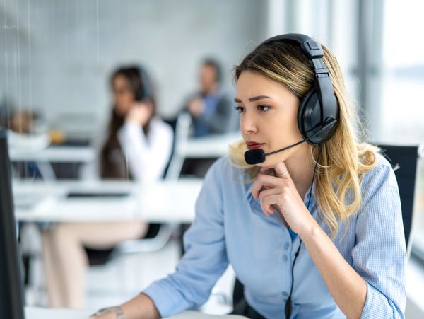 Woman with headset working in a call center office.