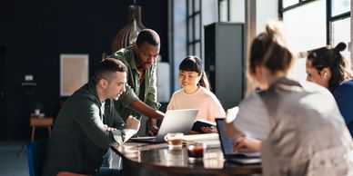A group of professionals having a discussion around a table 