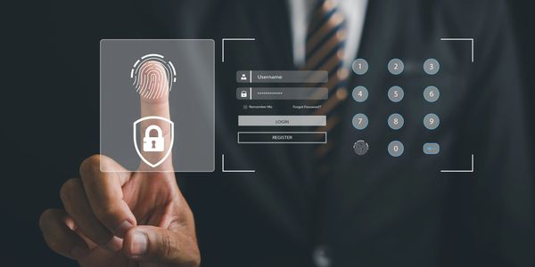 Businessman using fingerprint login for secure access.