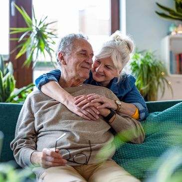 older couple hugging on couch