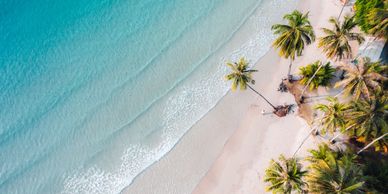 Overhead of beach with clear blue water