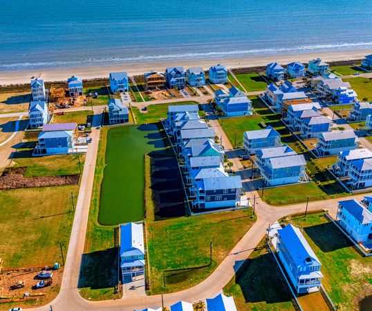 Aerial view of coastal houses near the beach.