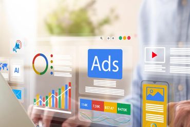 Person using laptop and smartphone with digital marketing analytics and ad data overlays.