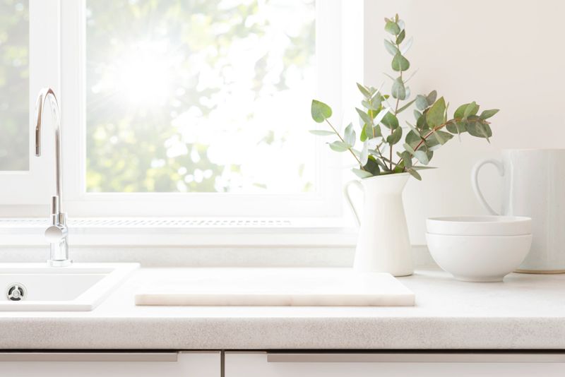 Marble pedestal for montage on kitchen counter over blurred window background