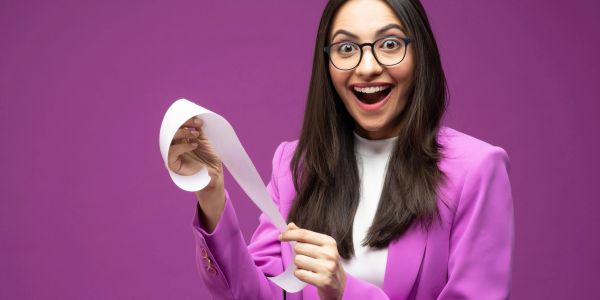 Excited woman holding a long receipt.