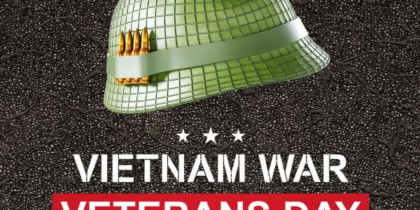 Green military helmet with bullets and Vietnam War Veterans Day text.
