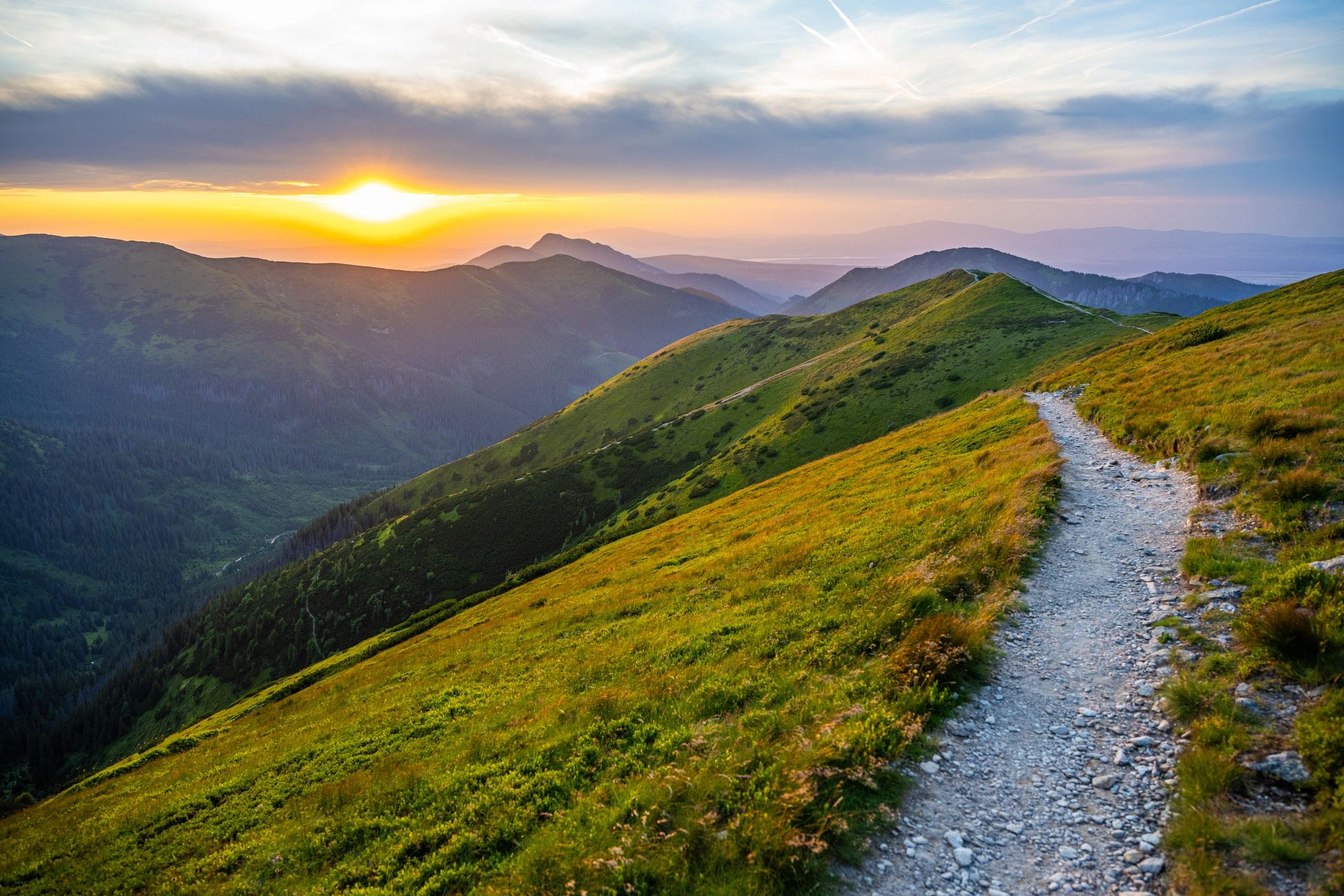 mountain range with a rocky path going into the distance 