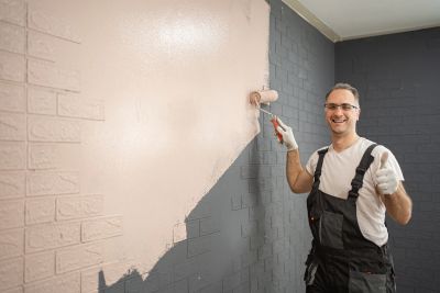Empire Finish Co painter applying interior wall paint during a residential painting project